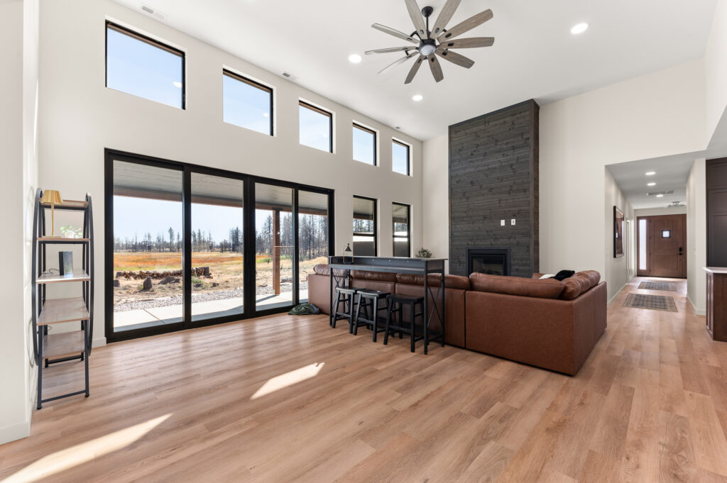 2024 People's Choice Award Winner. Living room and wall of windows.