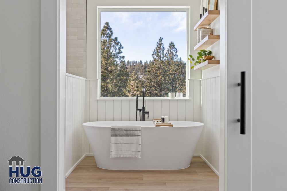 Interior photo of the bathroom with soaking tub and large picture window.