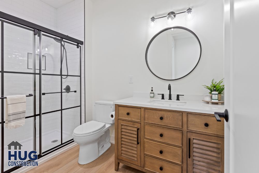 Interior photo of the bathroom with shower and vanity.