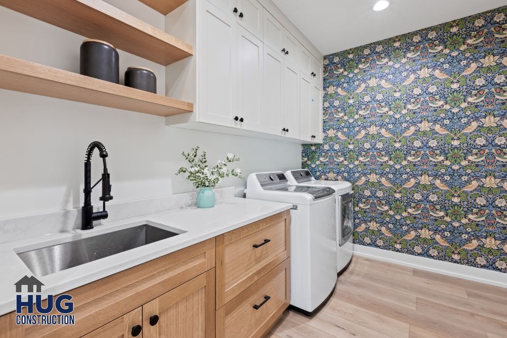 Interior photo of the laundry room with sink and appliances.