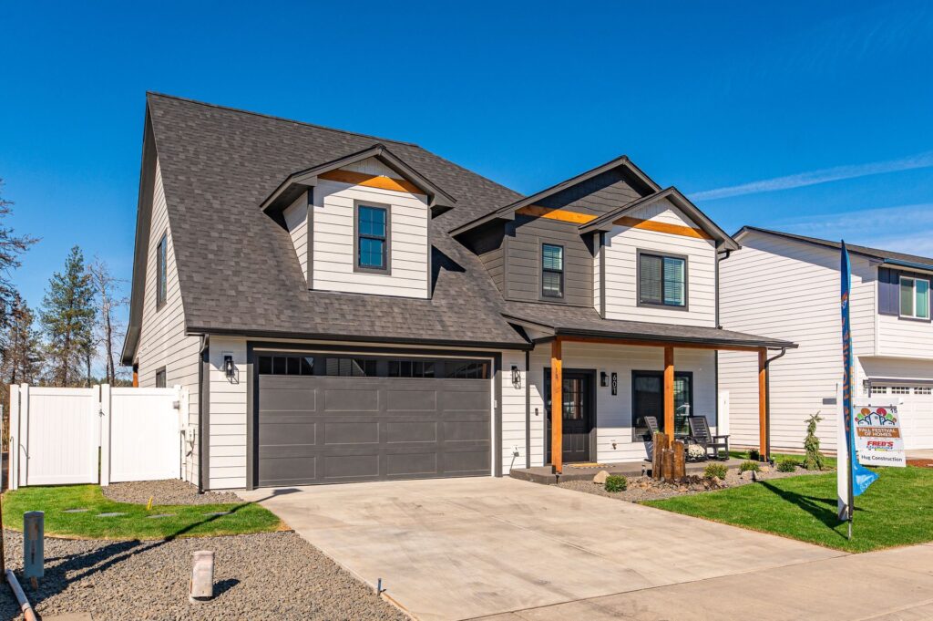 A photo of a new custom home with front entrance and garage.