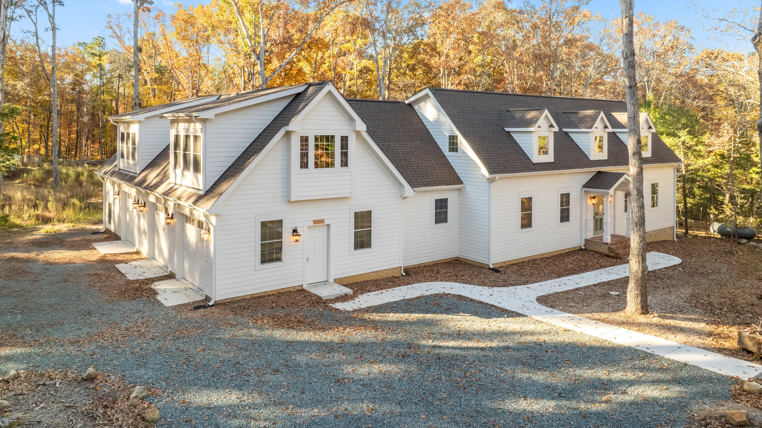 Aerial exterior view of the Loblolly Pine custom home in a wooded setting
