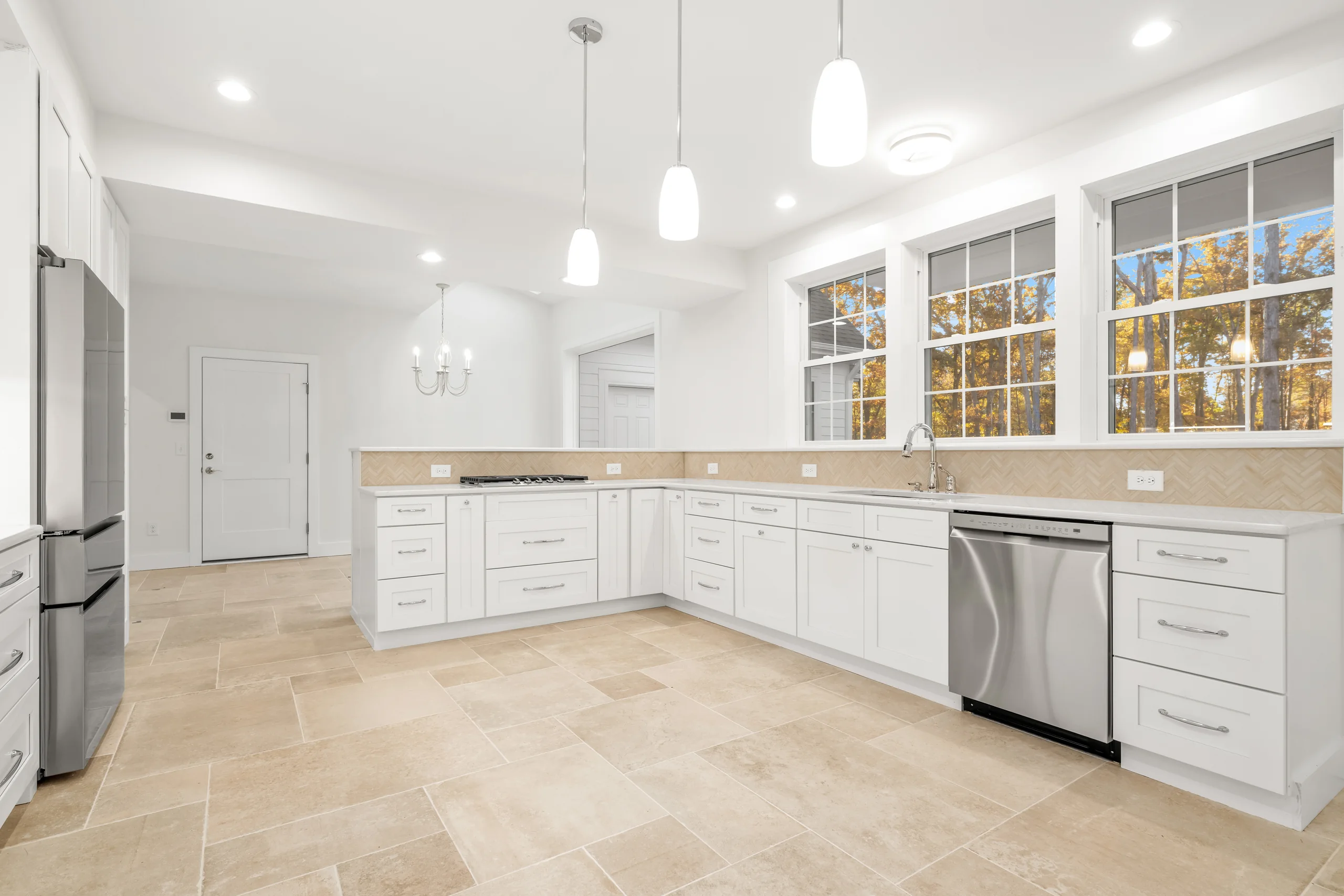 Loblolly-Pine-003 | Hug Construction Bright white kitchen with a large island and wooded views