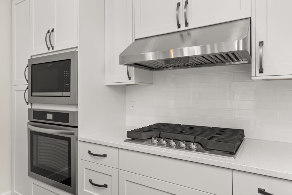 ADU-78. Interior photo of kitchen island with stovetop and range hood.