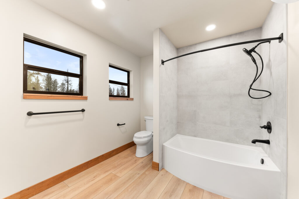 Alderwood. Interior photo of the bathroom tub and shower.