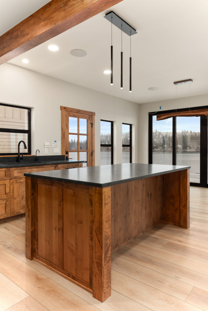 Alderwood. Interior photo of the kitchen island with modern lighting fixture.