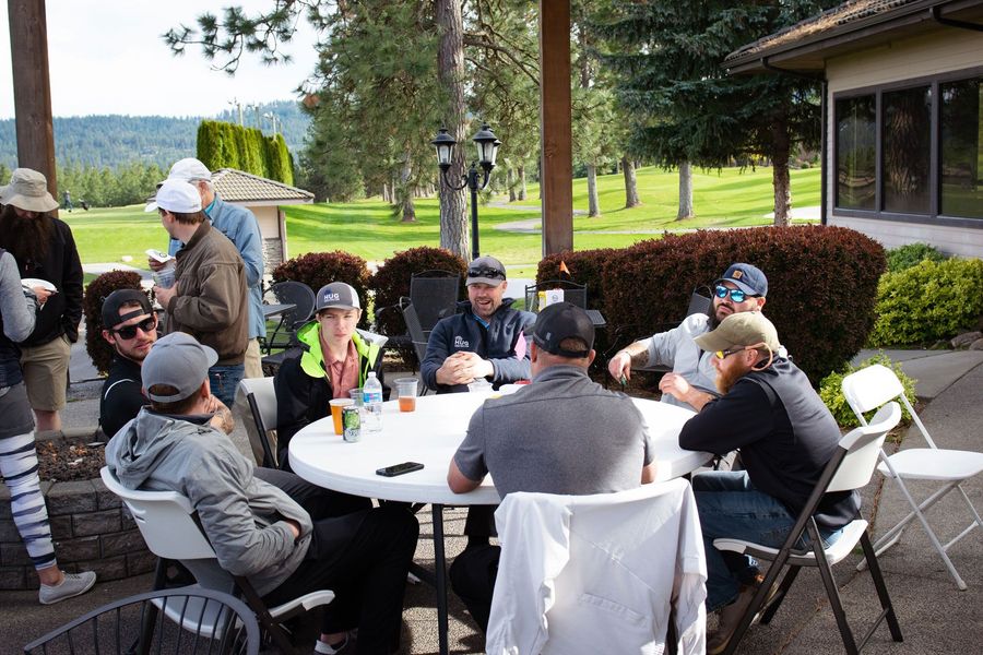 Giving. A photo showing Hug Construction employees sitting around a round table.