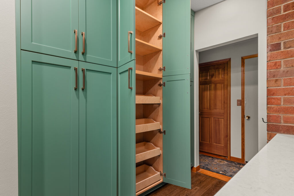 KitchenRemodel-84. Interior photo of pantry door with pull out shelving.