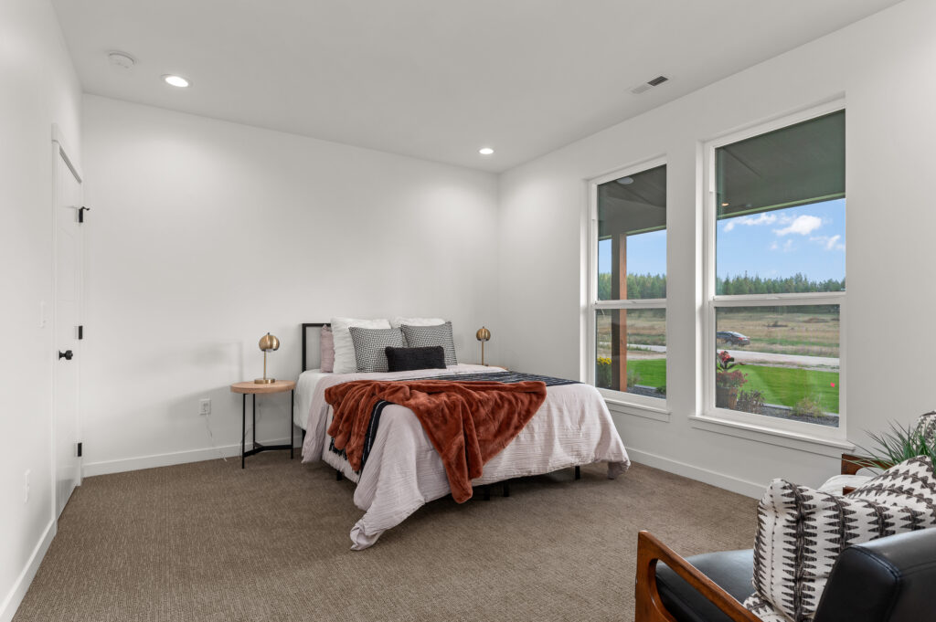 Interior shot of a bed in a bedroom.