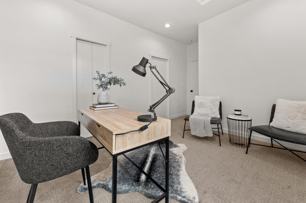 Interior shot of an office with desk and seating area.