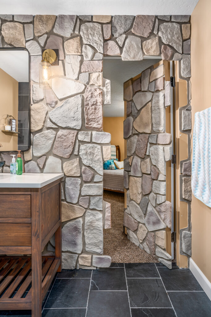 South Summerwood Basement Remodel. Interior photo of hidden stone covered door.