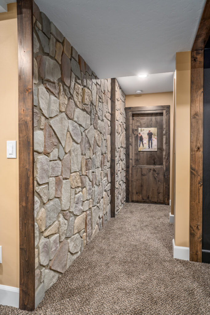 South Summerwood Basement Remodel. Interior photo of hallway in stone.