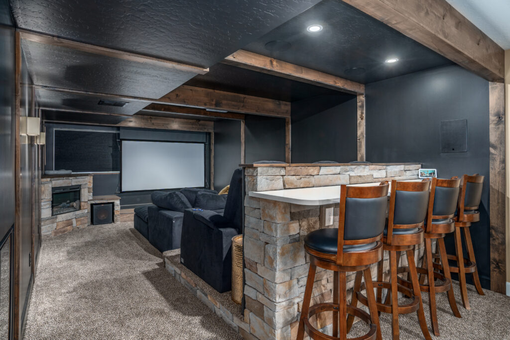 South Summerwood Basement Remodel. Interior photo of home theater and seating.