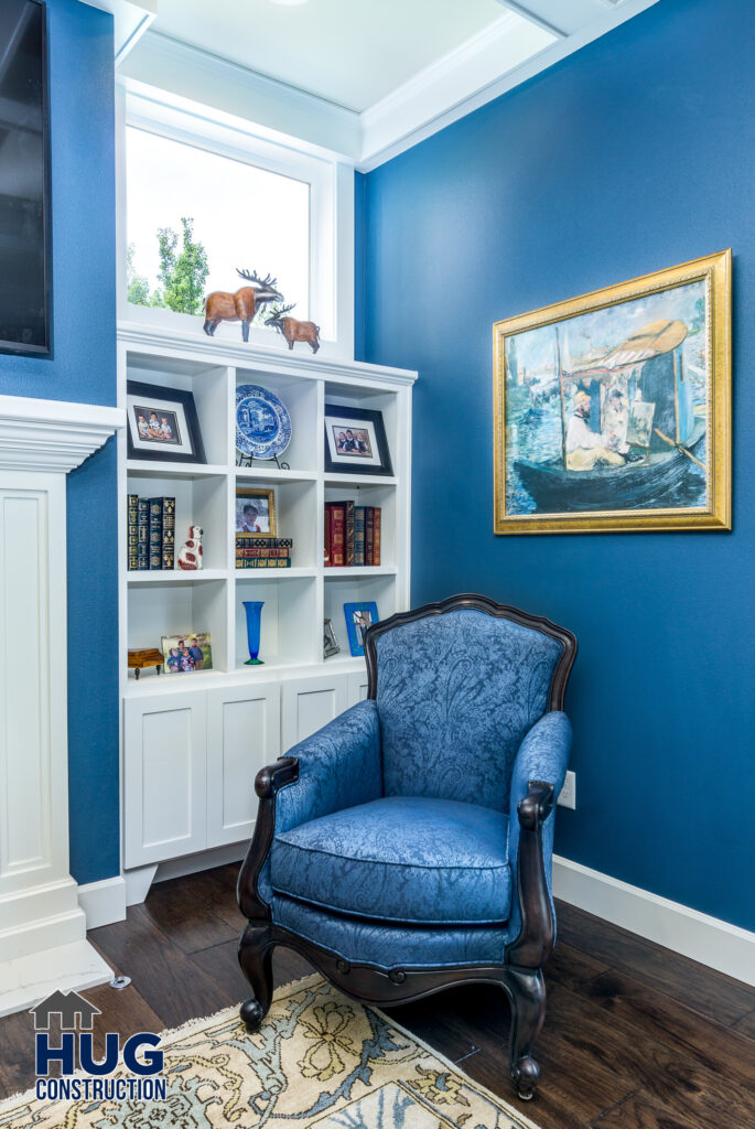 Bookshire Living Room Remodel. Interior photo of built-in bookcase and sitting chair.