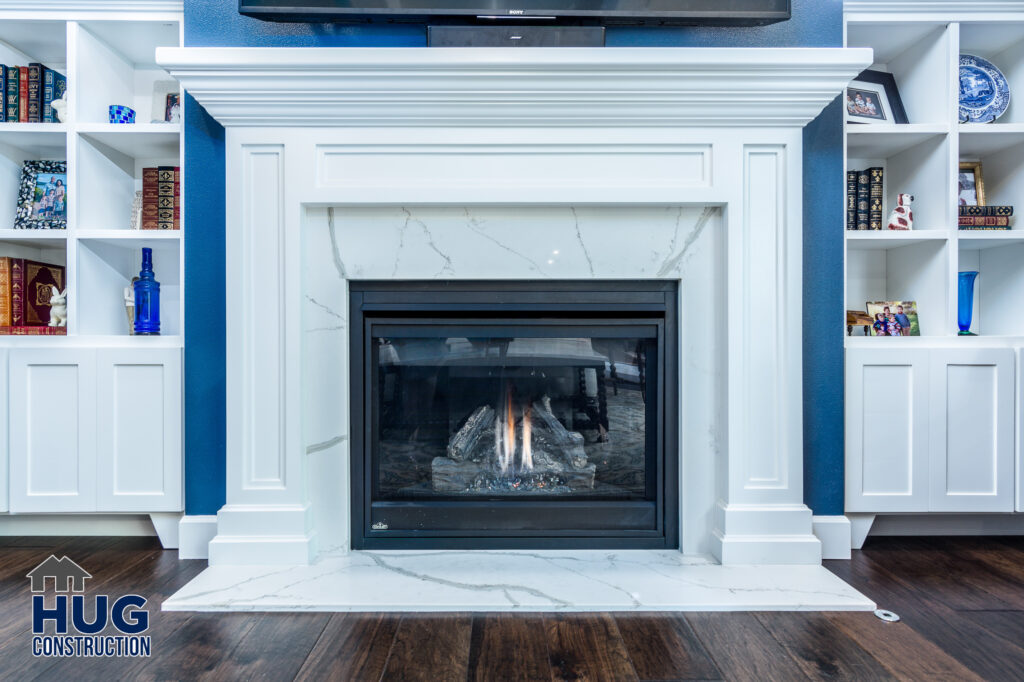 Bookshire Living Room Remodel. Interior photo of built-in bookcases and fireplace.