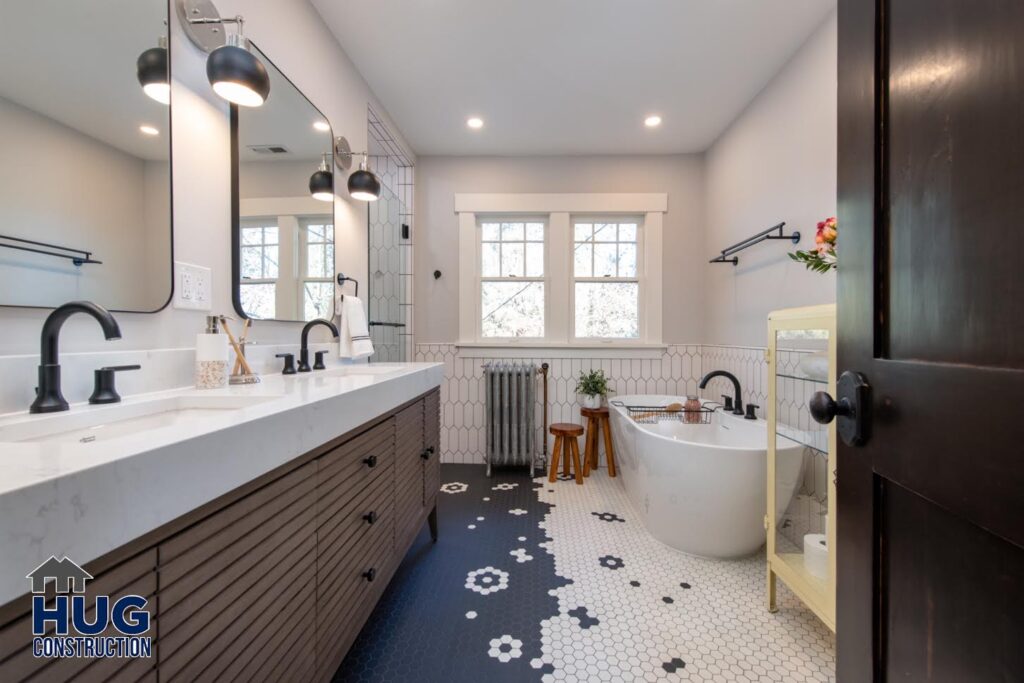 21st Ave Bathroom Remodel. Interior photo of the double vanity, soaking tub, and unique floor tile pattern.