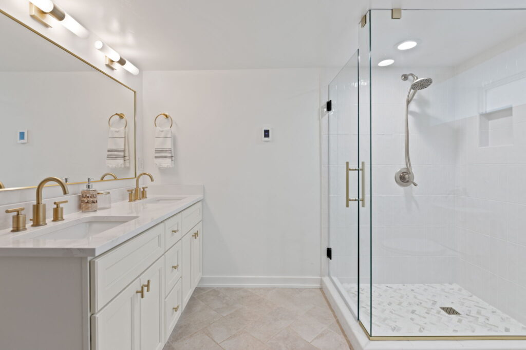 24th Ave Kitchen and Addition Remodel. Interior shot of bathroom with double vanity and shower.