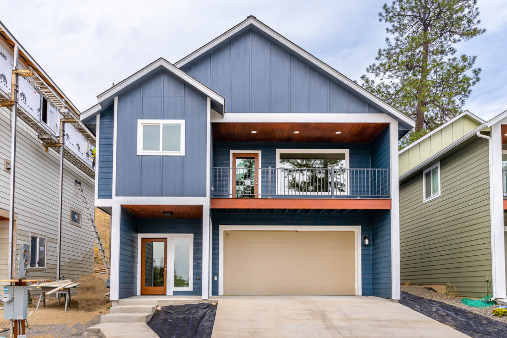 Custom Residential Home. Exterior photo of the home with second floor deck and garage.