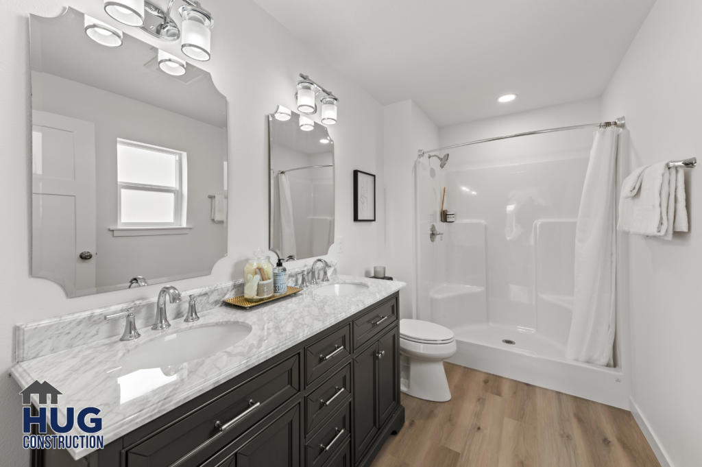 West Cora Avenue Custom Residential Home. Interior photo of a bathroom with double vanity and shower.