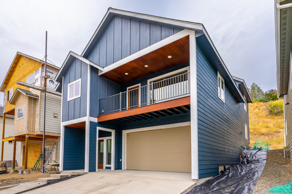 West Cora Avenue Custom Residential Home. Exterior photo of the home with second floor deck and garage.