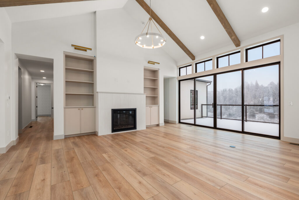 Luxury Custom Home Living Room Fireplace and Wall of Windows.